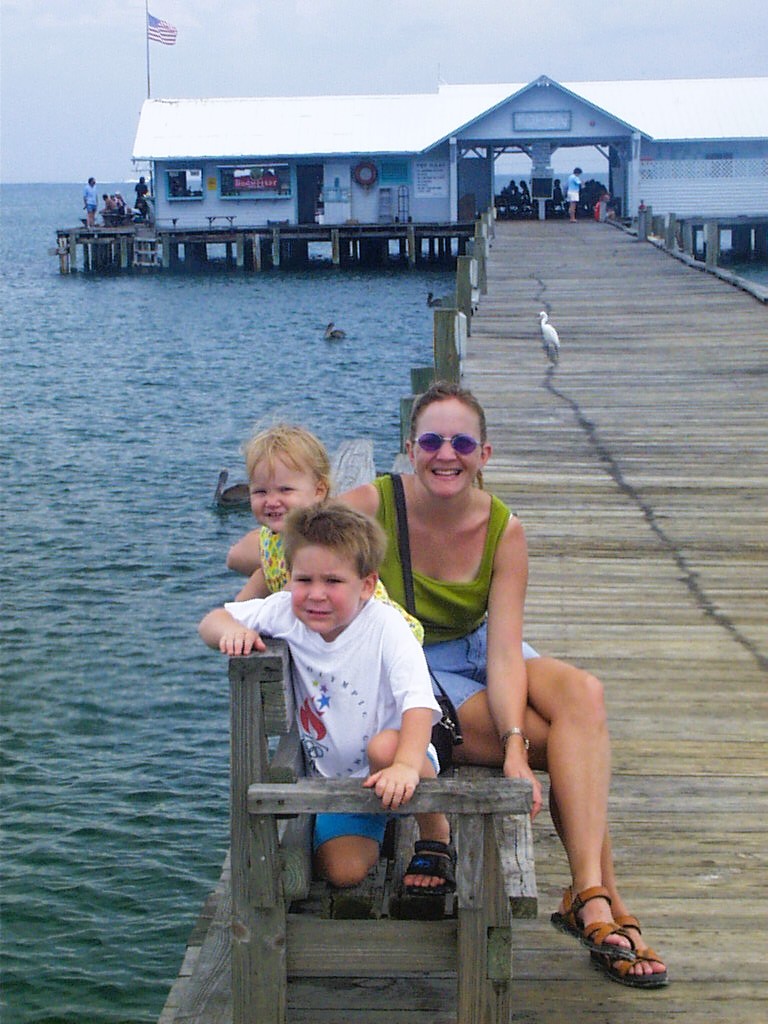 Mother and children on Anna Maria City Pier with Gulf waters in background