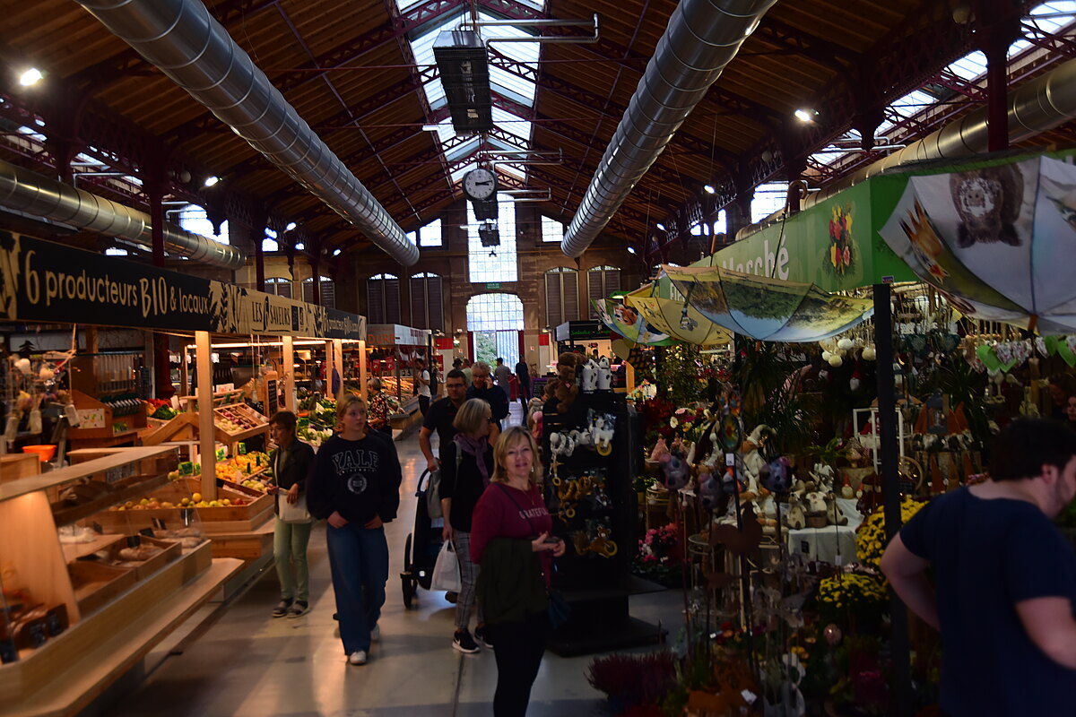 Fresh produce and specialty food vendors inside Colmar's Covered Market.