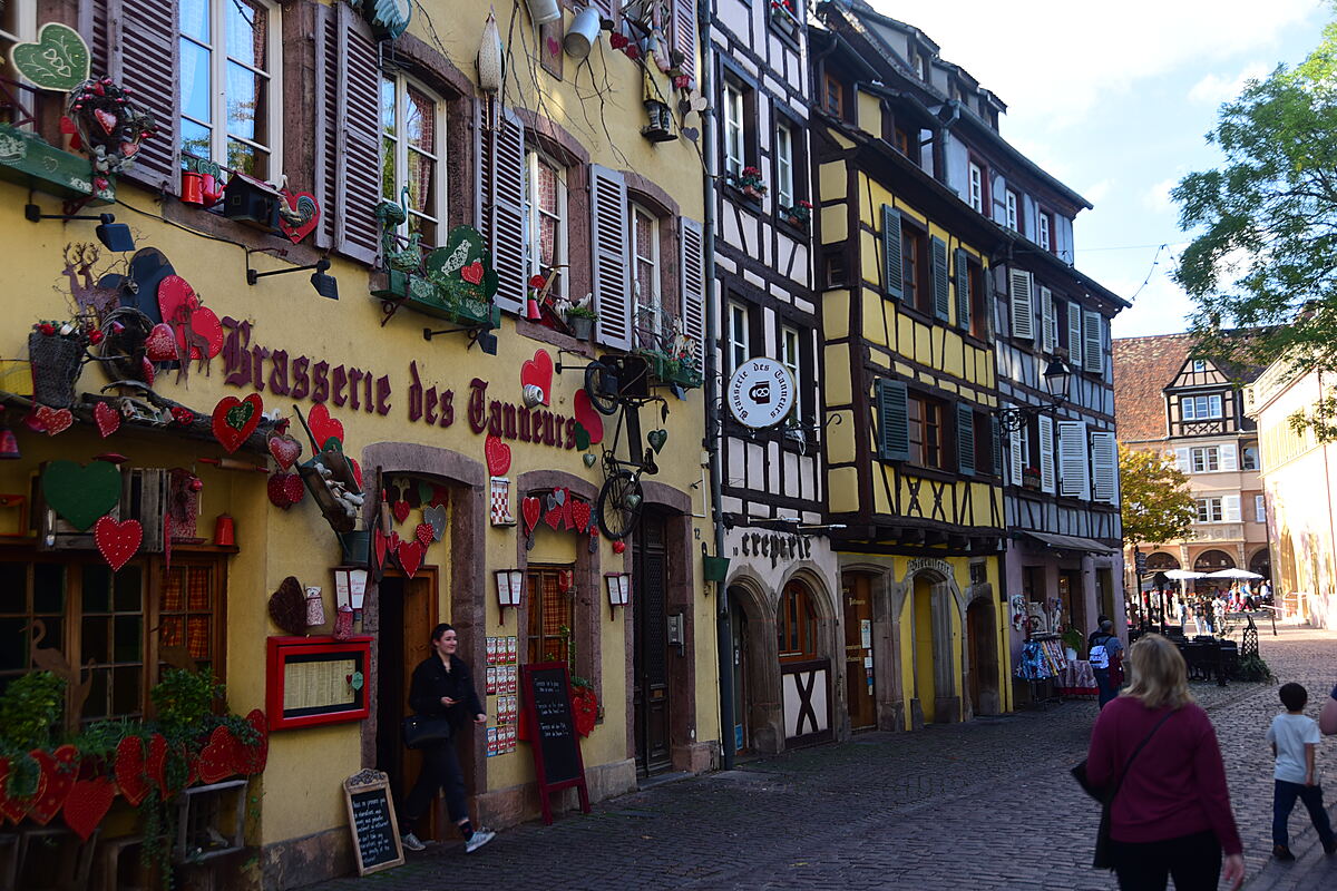 Half-timbered buildings along a historic street in Colmar, France.
