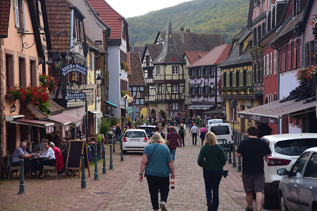 Historic half-timbered buildings and sidewalk caf&eacute;s in Kaysersberg, Alsace.